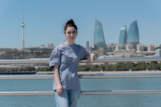 Woman poses in front of a city skyline.
